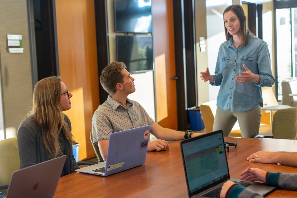 female teaching a group of colleagues