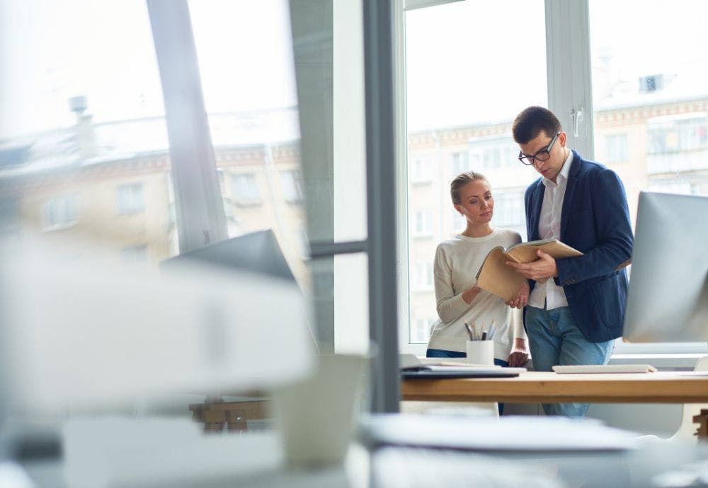 Employees going over the employee handbook